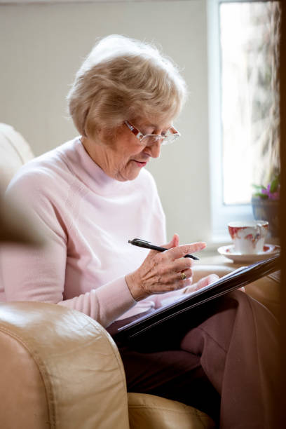 istock Senior Woman Writing at Home 952119374