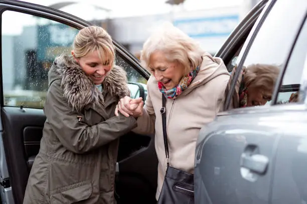 Photo of Helping a Senior Woman Out of the Car