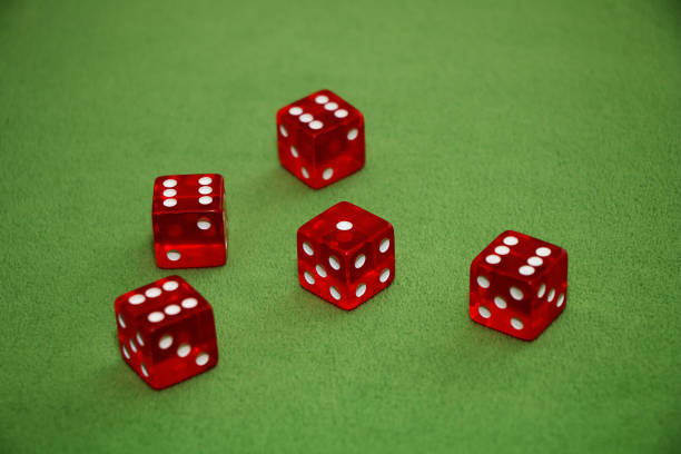 istock Red dices of a casino on a green table 952120694