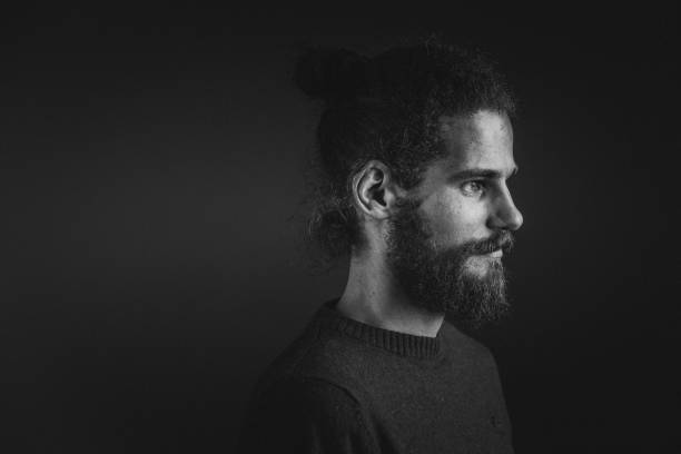 istock Young man with a beard and long curly hair 952121678