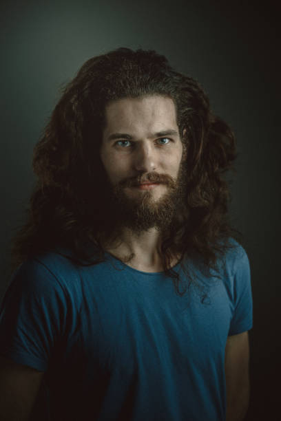 istock Young man with a beard and long curly hair 952121788