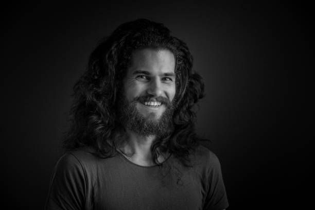 istock Young man with a beard and long curly hair 952121806