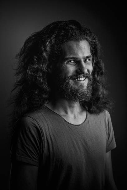 istock Young man with a beard and long curly hair 952121834