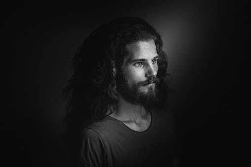 Young man with a beard and long curly hair