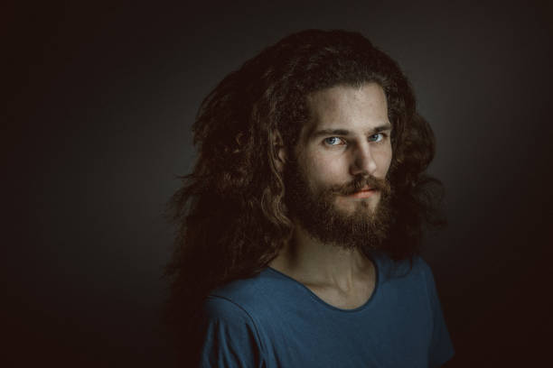 istock Young man with a beard and long curly hair 952121960