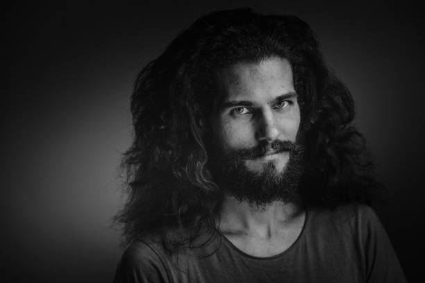 istock Young man with a beard and long curly hair 952121982