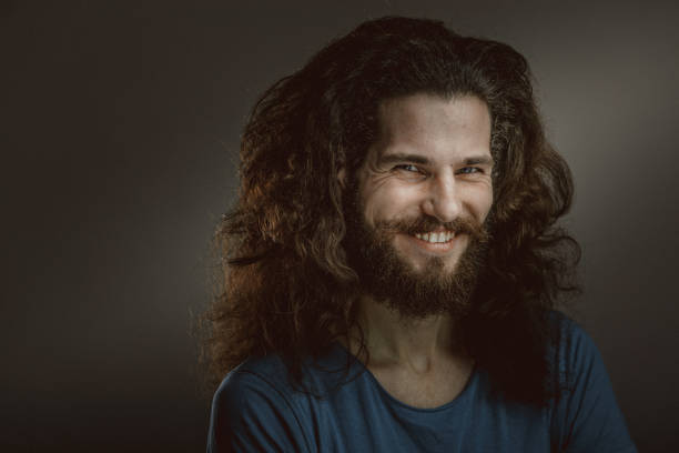 istock Young man with a beard and long curly hair 952122004