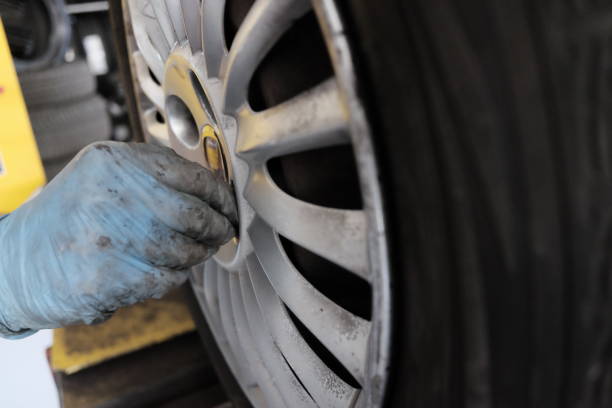 istock tire repairer replaces tire 952123918