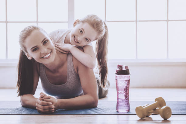 istock Mother and daughter doing sport 952126966