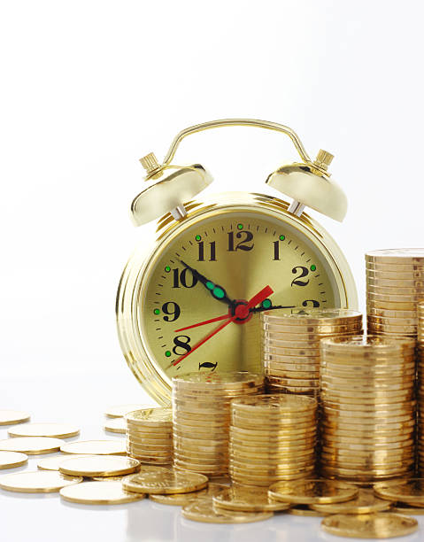 istock Clock and coins, time is money concept 95212740