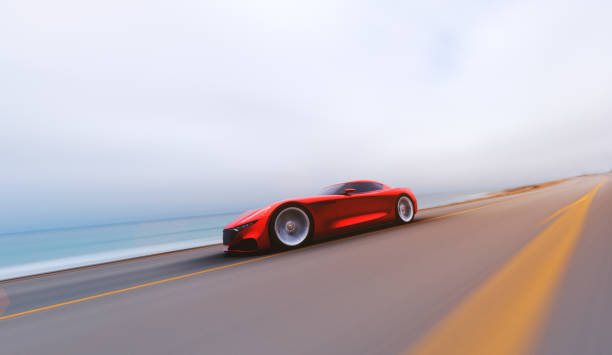 istock red car driving on a road by sea 952130944