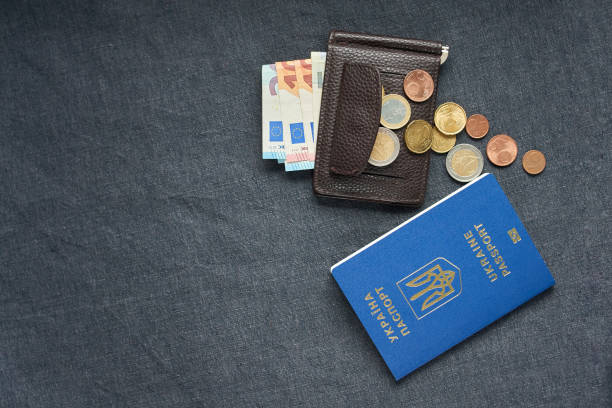 istock Ukraine passport with Euro Bills inside. On a gray backgraund 952131906