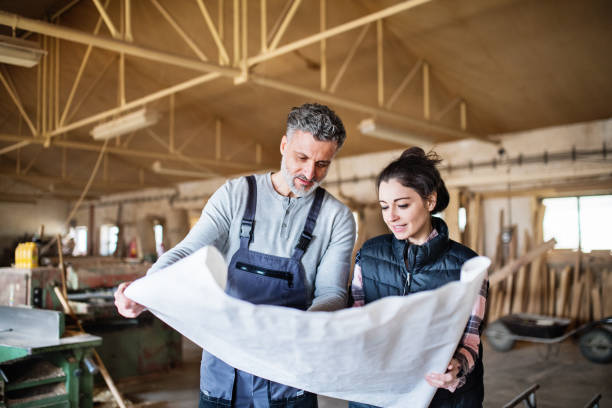 istock Man and woman workers in the carpentry workshop. 952131988