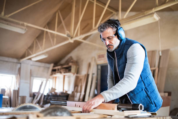 istock A man worker in the carpentry workshop, working with wood. 952132248