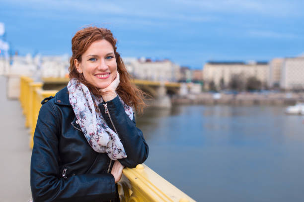 istock Happy young redhead woman posing on Margaret Bridge Budapest 952186054