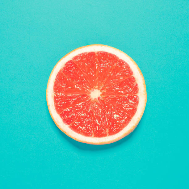 istock Grapefruit slice on pastel blue background. Minimal summer concept. Flat lay. 952186448