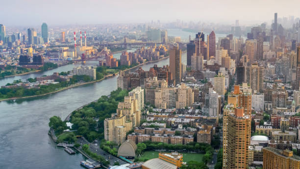 Yorkville, Manhattan and the Roosevelt Island Aerial shot of the Yorkville neighborhood in Manhattan with the Roosevelt Island. Shot in NYC, USA. roosevelt island stock pictures, royalty-free photos & images