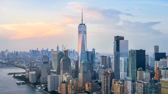 Aerial shot of the Lower Manhattan and the Freedom Tower reflecting the clouds. Shot in USA.