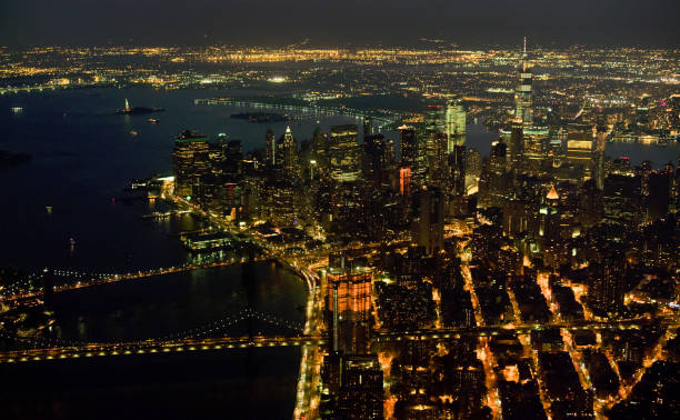 Aerial shot of the Lower Manhattan with Brooklyn Bridge at night. Shot in NY, USA.