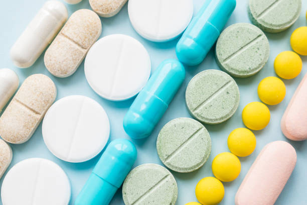 Opioid painkillers crisis and drug abuse concept Opioid painkillers crisis and drug abuse concept. Opioid and prescription medication addiction epidemic. Different kinds of multicolored pills. Pharmaceutical medicament background generic description stock pictures, royalty-free photos & images
