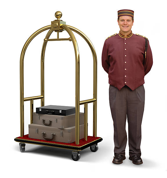 Bellhop with Luggage Cart Bellhop in retro uniform and luggage cart on a white background with clipping path on bellman bellhop photos stock pictures, royalty-free photos & images