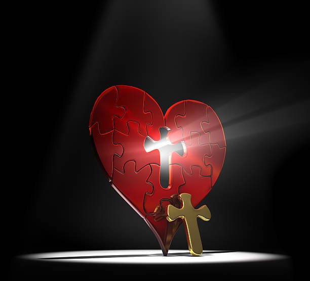 Heart shaped puzzle with a cross removed from the center stock photo