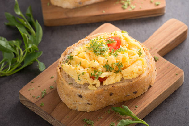 istock Tasty sandwich with egg and vegetables on old wood block background 952296566