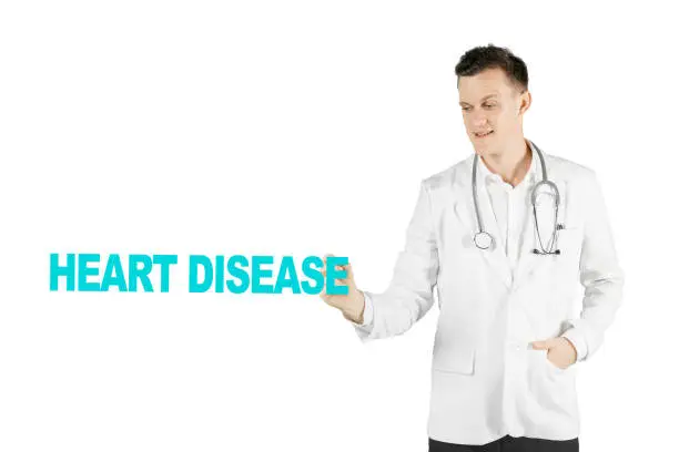 Image of Caucasian male physician is writing heart disease text on the whiteboard, isolated on white background