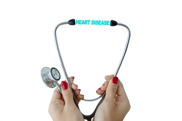 Closeup of female doctor hands holding a stethoscope with heart disease text, isolated on white background