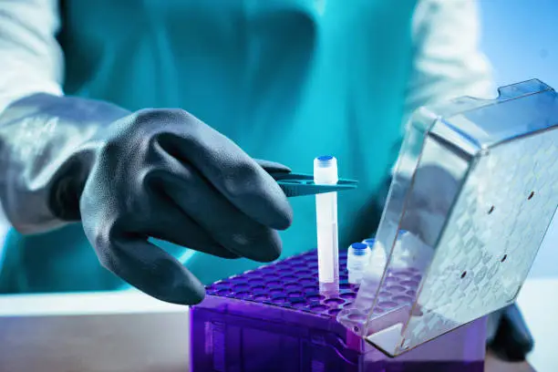 Photo of Biobanking. Technician preparing biological sample for deep freezing