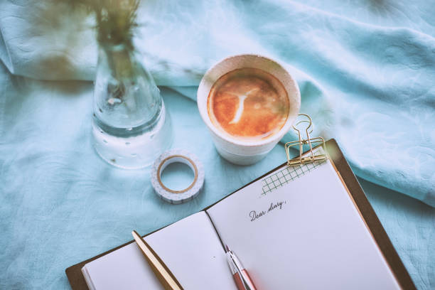 istock Diary and a cup of coffee on a turquoise napkin 952308618