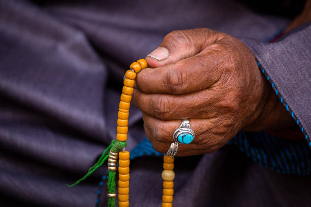 Old Tibetan woman holding buddhist rosary in Hemis monastery, Ladakh, India. Hand and rosary, close up Old hands of a Tibetan woman holding prayer buddhist beads at a Hemis monastery, Leh district, Ladakh, Jammu and Kashmir, north India. Close up ladakh region photos stock pictures, royalty-free photos & images