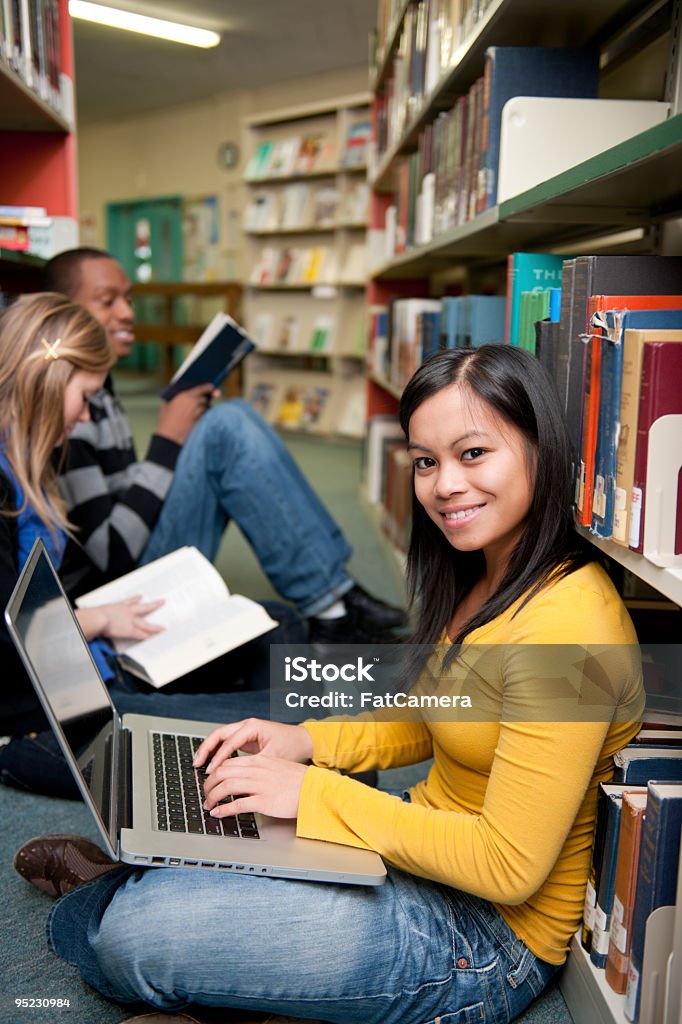 Library College students studying in a library of books. Library Stock Photo