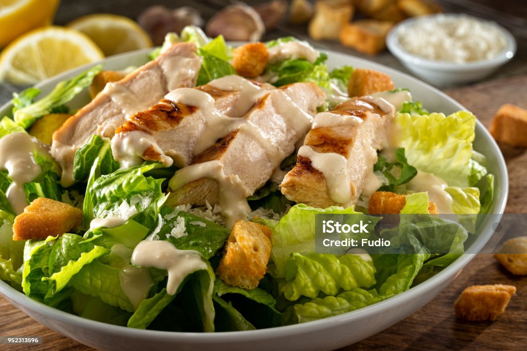 Chicken Caesar Salad A delicious chicken caesar salad with parmesan cheese, dressing and croutons. Salad Stock Photo