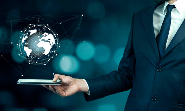 istock Businessman touch tablet PC screen with blue internet globe 952313822