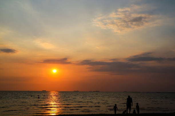 istock man and children play on beach and sunset 952313928