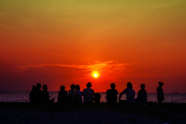 istock silhouette family meeting and looking sunset on beach 952323162