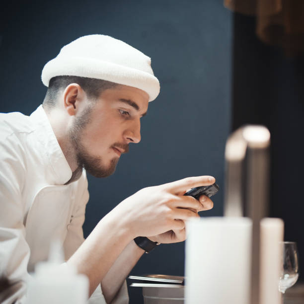 istock Restaurant Chef cook holding mobile phone. 952323780