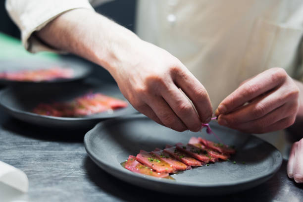 istock Restaurant Chef cook preparing tuna striped filet and crambling salad on the fish. 952323938