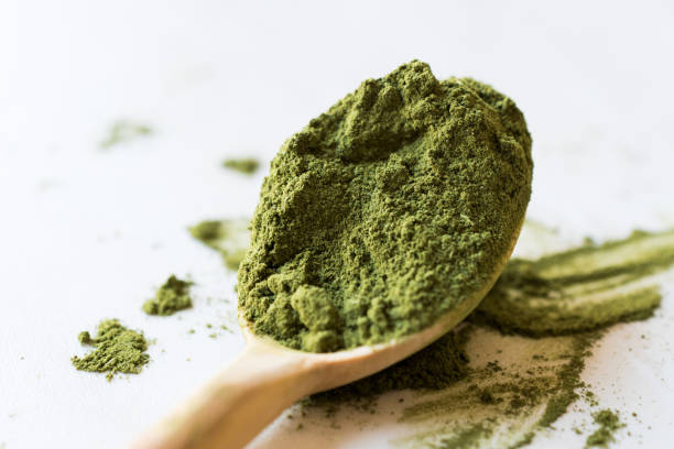 istock Green Matcha Tea Powder in Wooden Spoon. 952324004