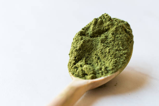 istock Green Matcha Tea Powder in Wooden Spoon. 952324270