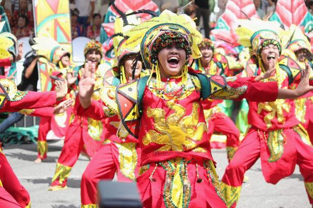 Kadayawan Festival, Davao City photos DAVAO CITY, PHILIPPINES—AUGUST 2014: Participating teams giving their best in performance at the streets. davao city stock pictures, royalty-free photos & images