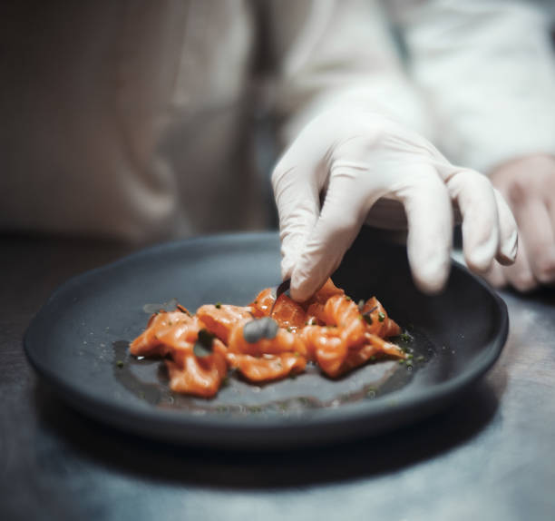 istock Restaurant Chef cook preparing salmon filet and vegetables 952324462