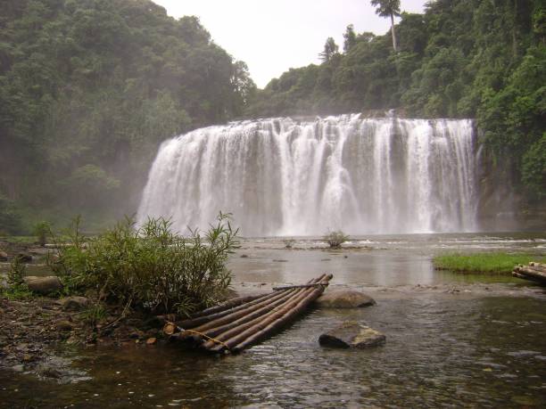 istock Front view of Tinuy-an Falls with a bamboo raft in the foreground. 952333040