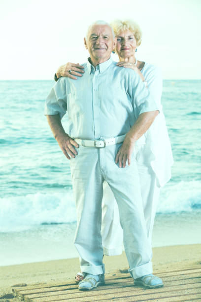 istock pensioners standing together on the sea coast 952333180