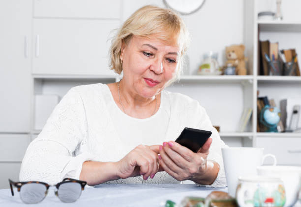 istock Mature woman with smartphone 952333736