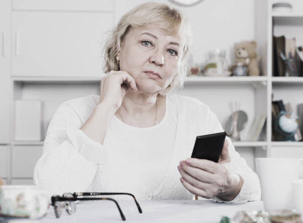 istock Mature woman with smartphone 952333770