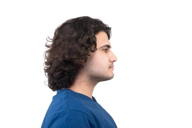 istock Profile view of young man looking away with blank facial expression on a white background 952338662