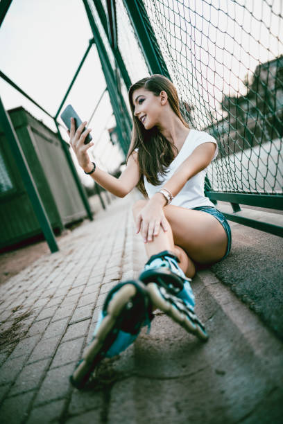 istock Smiling Young Girl Taking Selfie During Roller Blading in Skate Park 952355596