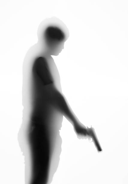 Man holding a gun behind the frosted glass
